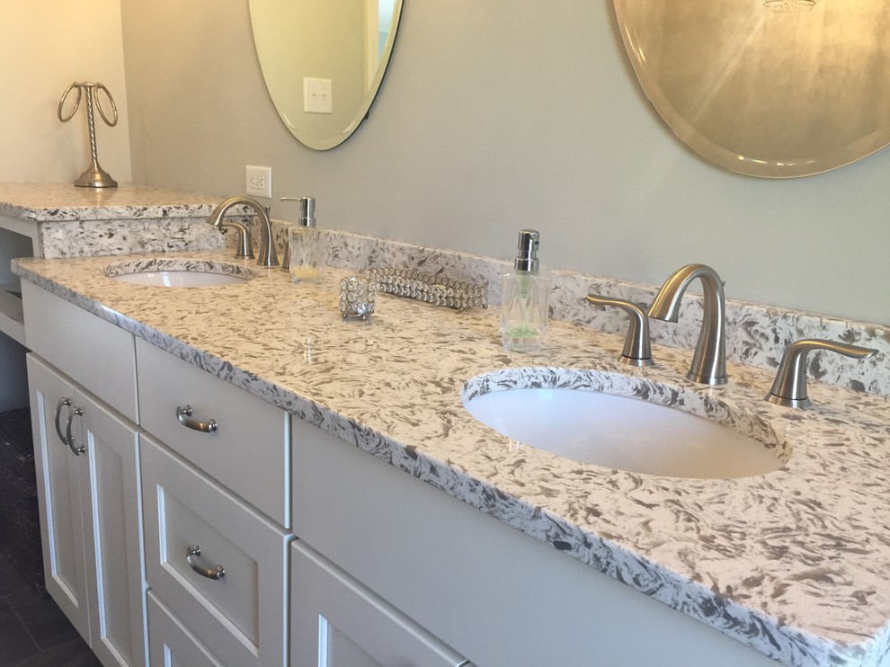 Mid-sized transitional master bathroom in Indianapolis with recessed-panel cabinets, white cabinets, a freestanding tub, a corner shower, porcelain tile, grey walls, porcelain floors, an undermount sink and engineered quartz benchtops.