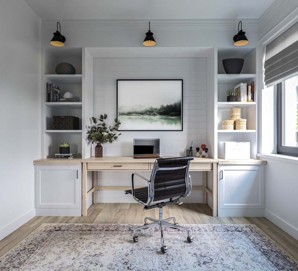 This is an example of a medium sized home office in Other with white walls, laminate floors, a freestanding desk and brown floors.