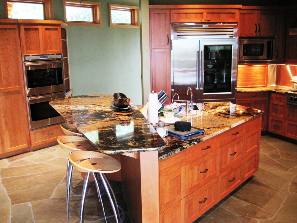 Example of a large transitional slate floor kitchen design in Seattle with flat-panel cabinets, light wood cabinets, granite countertops and an island