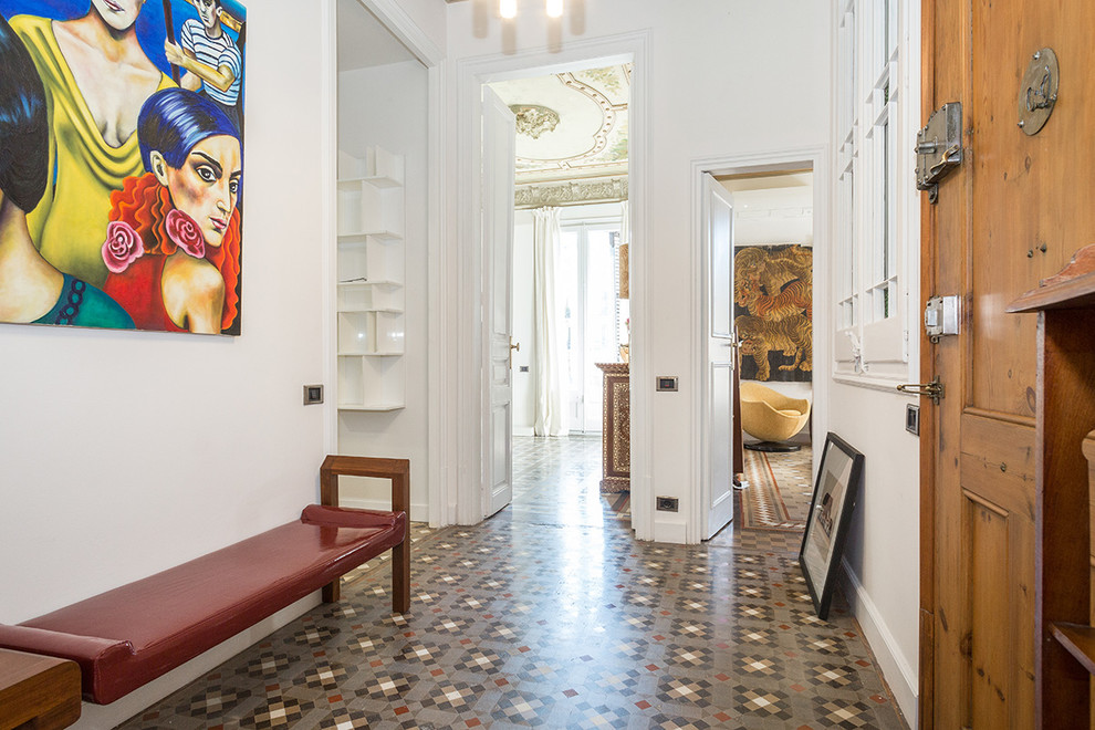 Inspiration for a mid-sized eclectic entryway in Barcelona with white walls, a single front door, a medium wood front door and ceramic floors.