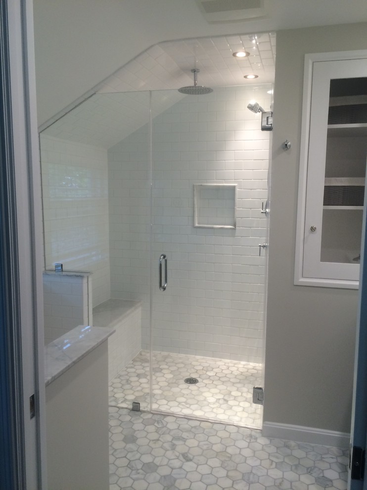 Photo of a small transitional master bathroom in DC Metro with furniture-like cabinets, dark wood cabinets, a curbless shower, gray tile, stone tile, marble floors, an undermount sink and marble benchtops.
