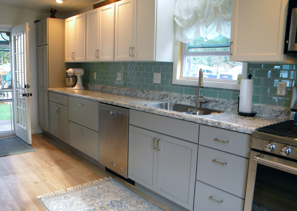 Large transitional single-wall kitchen pantry photo with a drop-in sink, recessed-panel cabinets, white cabinets, stainless steel appliances and no island