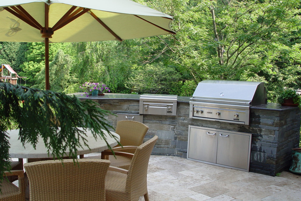 This is an example of a mid-sized mediterranean backyard patio in New York with an outdoor kitchen, tile and no cover.