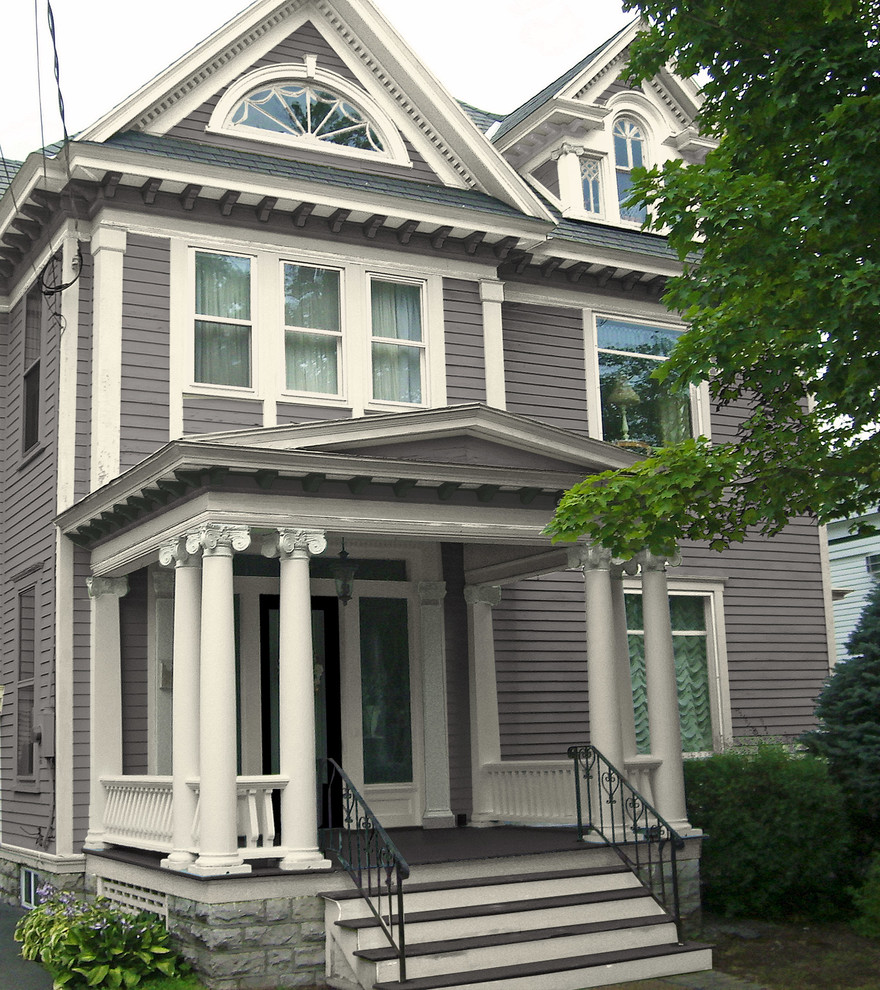 Inspiration for a large traditional two-storey grey exterior in New York with wood siding and a hip roof.