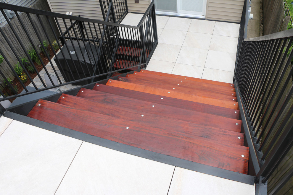 This is an example of a small modern rooftop deck in Chicago with no cover.