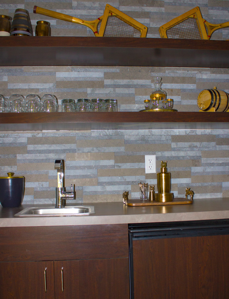This is an example of a small contemporary single-wall wet bar in Detroit with a drop-in sink, flat-panel cabinets, dark wood cabinets, granite benchtops, multi-coloured splashback, stone tile splashback and limestone floors.