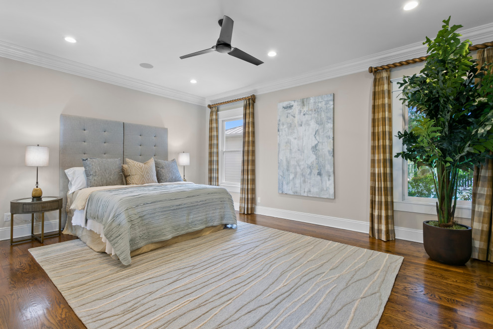 This is an example of a medium sized contemporary master bedroom in Tampa with beige walls, medium hardwood flooring and no fireplace.