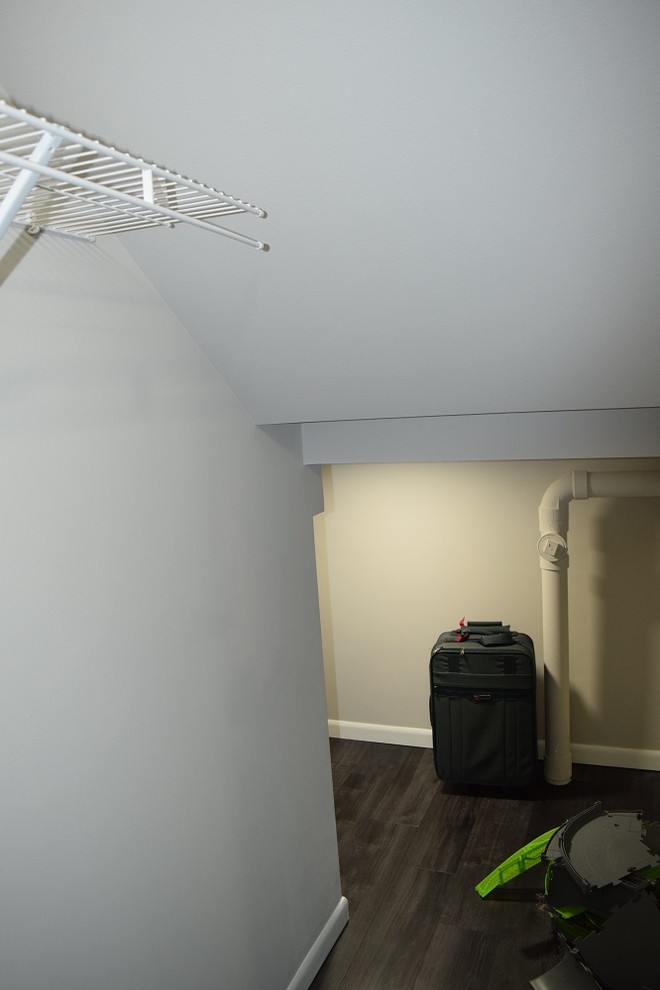 Example of a large transitional walk-out and enclosed vinyl floor home design design with white walls, no fireplace and no tv