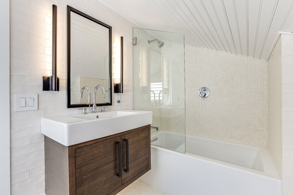 Photo of a mid-sized modern bathroom in Seattle with flat-panel cabinets, medium wood cabinets, a corner shower, a one-piece toilet, white tile, mosaic tile, white walls, mosaic tile floors, an integrated sink, solid surface benchtops, white floor, a hinged shower door and white benchtops.