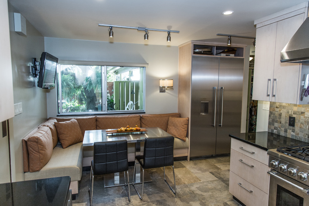 Small contemporary u-shaped eat-in kitchen in Other with a double-bowl sink, flat-panel cabinets, light wood cabinets, granite benchtops, green splashback, slate splashback, stainless steel appliances, slate floors, no island and green floor.