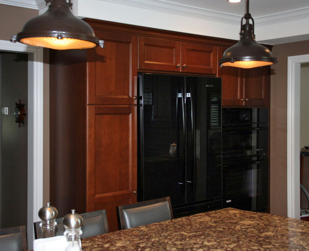 Mid-sized transitional l-shaped linoleum floor enclosed kitchen photo in Toronto with an undermount sink, shaker cabinets, medium tone wood cabinets, quartz countertops, gray backsplash, ceramic backsplash, black appliances and an island