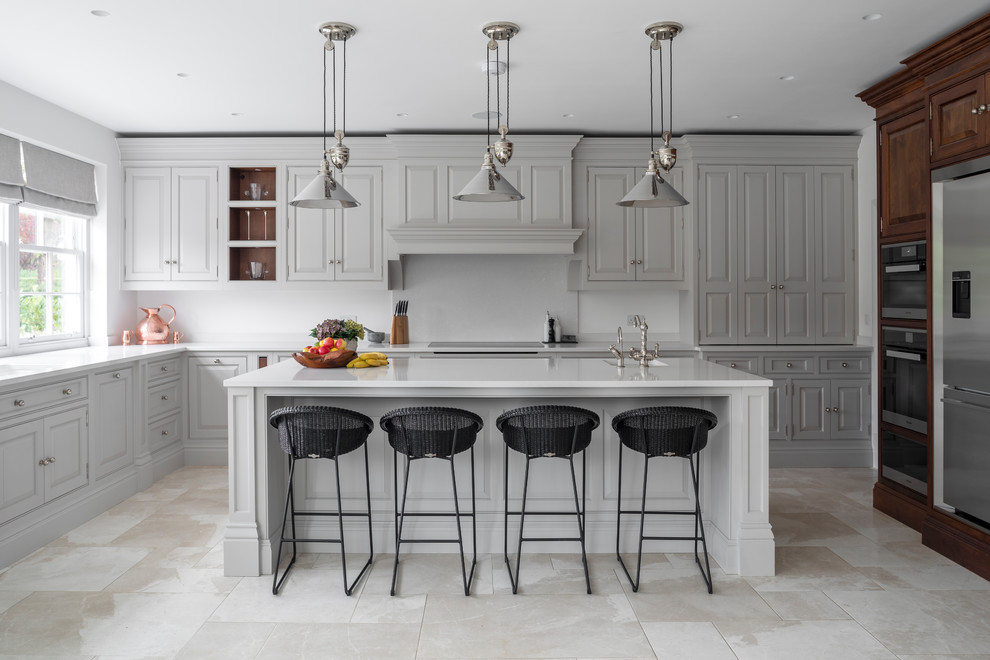 Transitional u-shaped kitchen in Other with an undermount sink, raised-panel cabinets, grey cabinets, stainless steel appliances, with island, beige floor and beige benchtop.