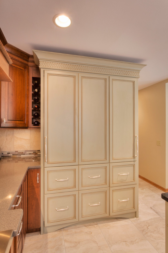 Inspiration for a large transitional l-shaped ceramic tile eat-in kitchen remodel with an undermount sink, raised-panel cabinets, medium tone wood cabinets, glass countertops, multicolored backsplash, mosaic tile backsplash, paneled appliances and an island
