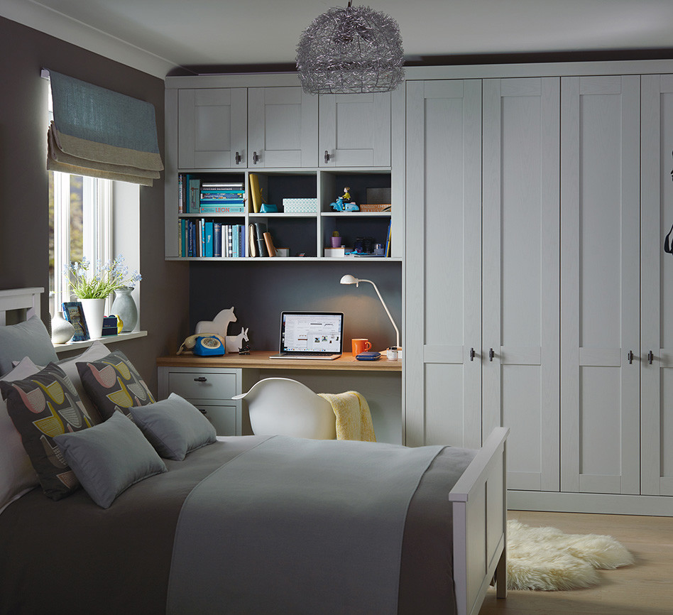 This is an example of a mid-sized transitional bedroom in Dublin with grey walls, light hardwood floors and beige floor.
