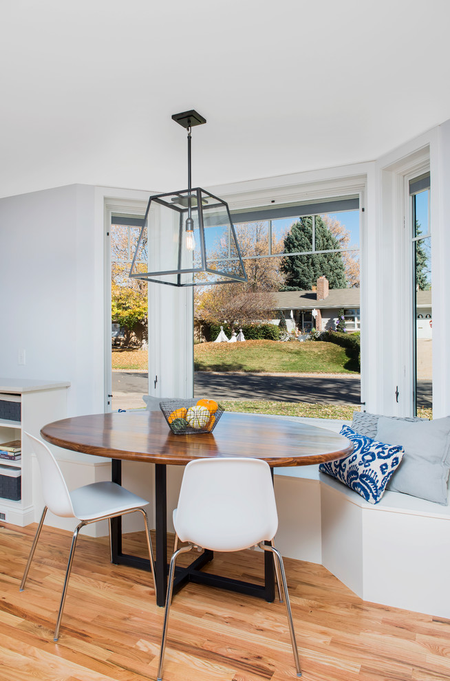 Example of a large transitional u-shaped light wood floor enclosed dining room design in Denver with a farmhouse sink, shaker cabinets, white cabinets, quartz countertops, gray backsplash, ceramic backsplash, stainless steel appliances and an island