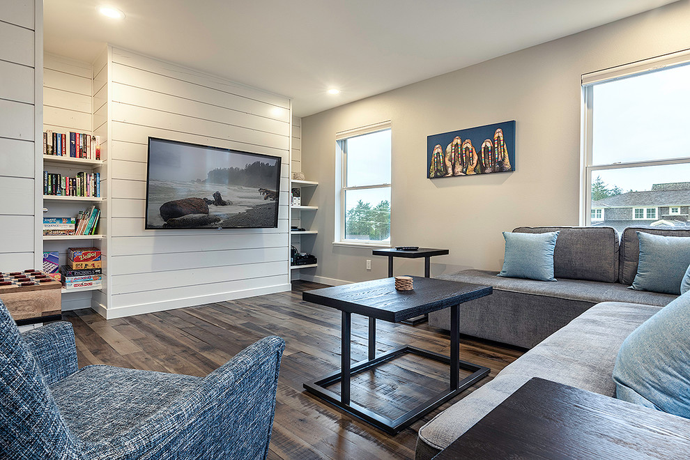 Inspiration for a mid-sized beach style family room in Seattle with a game room, white walls, medium hardwood floors, a wall-mounted tv and brown floor.