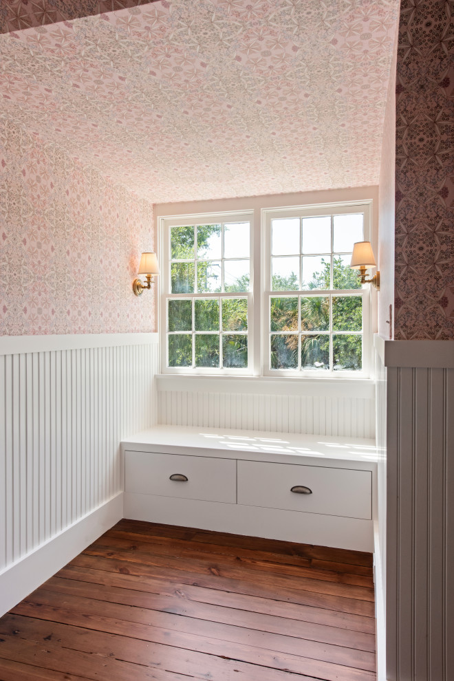 Classic kids' bedroom for girls in Charleston with pink walls, medium hardwood flooring, a wallpapered ceiling and wainscoting.
