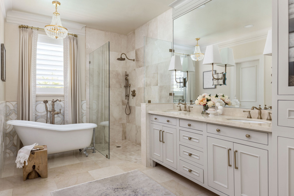 Photo of a small traditional master bathroom in Houston with recessed-panel cabinets, grey cabinets, a claw-foot tub, a curbless shower, beige tile, beige walls, an undermount sink, beige floor, an open shower, beige benchtops, a double vanity and a built-in vanity.