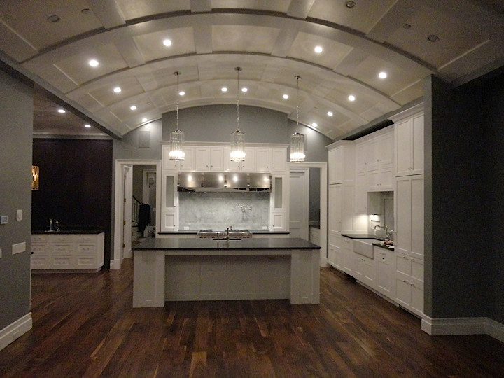 Example of a large transitional l-shaped kitchen design in Chicago with granite countertops, a farmhouse sink and stainless steel appliances