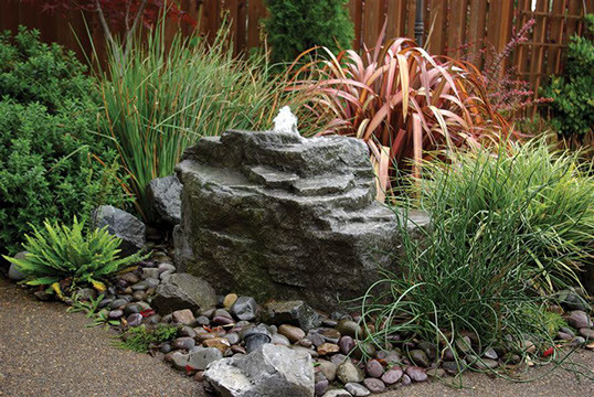 This is an example of a mid-sized traditional partial sun backyard brick water fountain landscape in Atlanta.