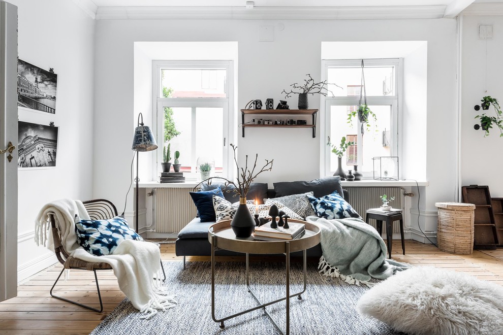 Inspiration for a mid-sized scandinavian formal open concept living room in Gothenburg with white walls, light hardwood floors and no fireplace.