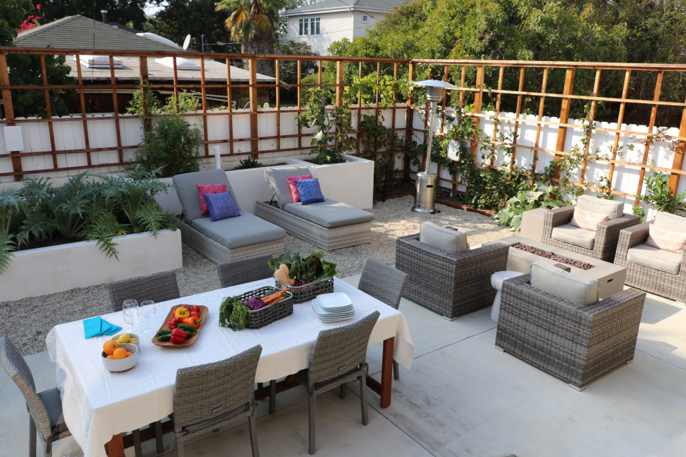 Example of a large beach style backyard gravel patio vegetable garden design in Los Angeles