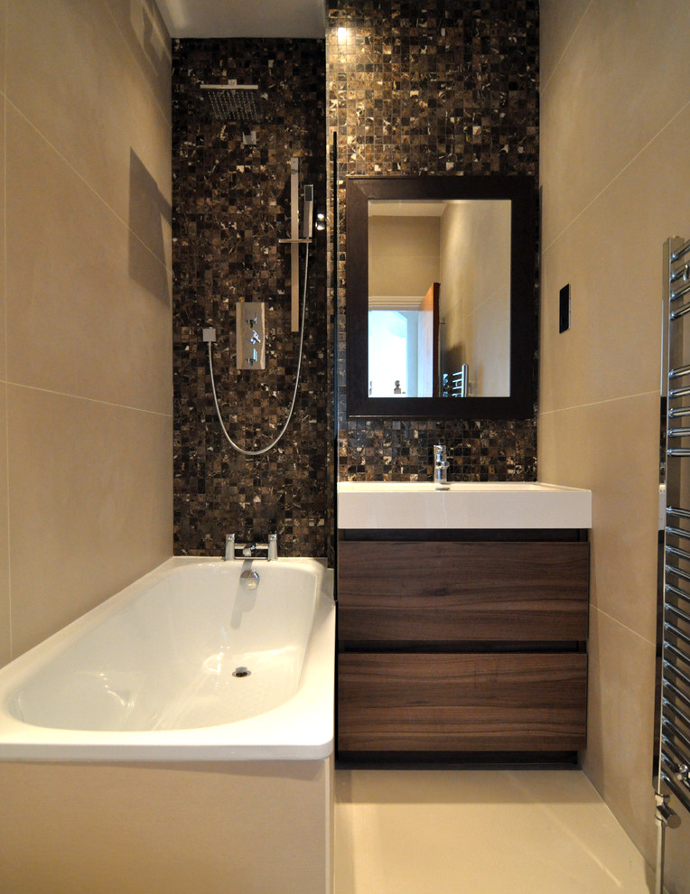Inspiration for a small contemporary kids bathroom in London with a drop-in sink, flat-panel cabinets, dark wood cabinets, solid surface benchtops, a drop-in tub, a curbless shower, brown tile, mosaic tile, beige walls and porcelain floors.