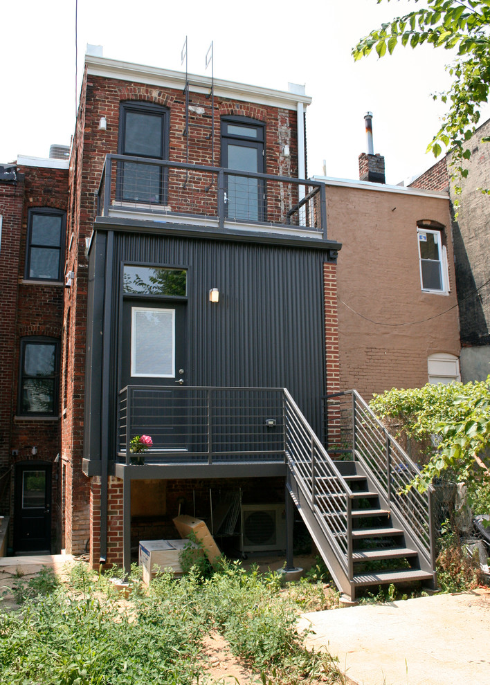 Small contemporary three-storey brick red exterior in DC Metro with a flat roof.