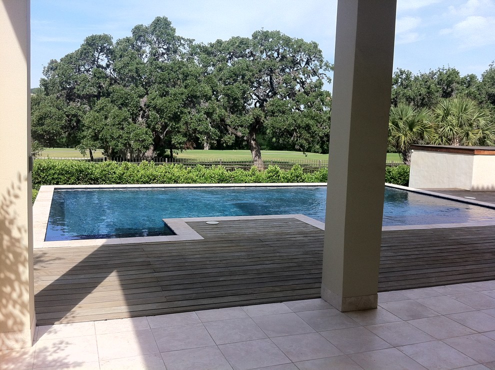 Inspiration for a large mediterranean backyard rectangular lap pool in Austin with decking.