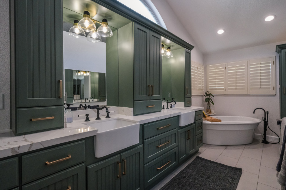 Inspiration for a large cottage master porcelain tile, gray floor, double-sink and vaulted ceiling freestanding bathtub remodel in San Francisco with recessed-panel cabinets, green cabinets, white walls, quartz countertops, a hinged shower door, white countertops, a built-in vanity and an undermount sink