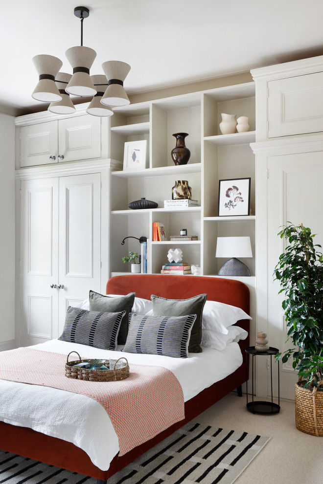 Photo of a classic bedroom in London with white walls, carpet and beige floors.