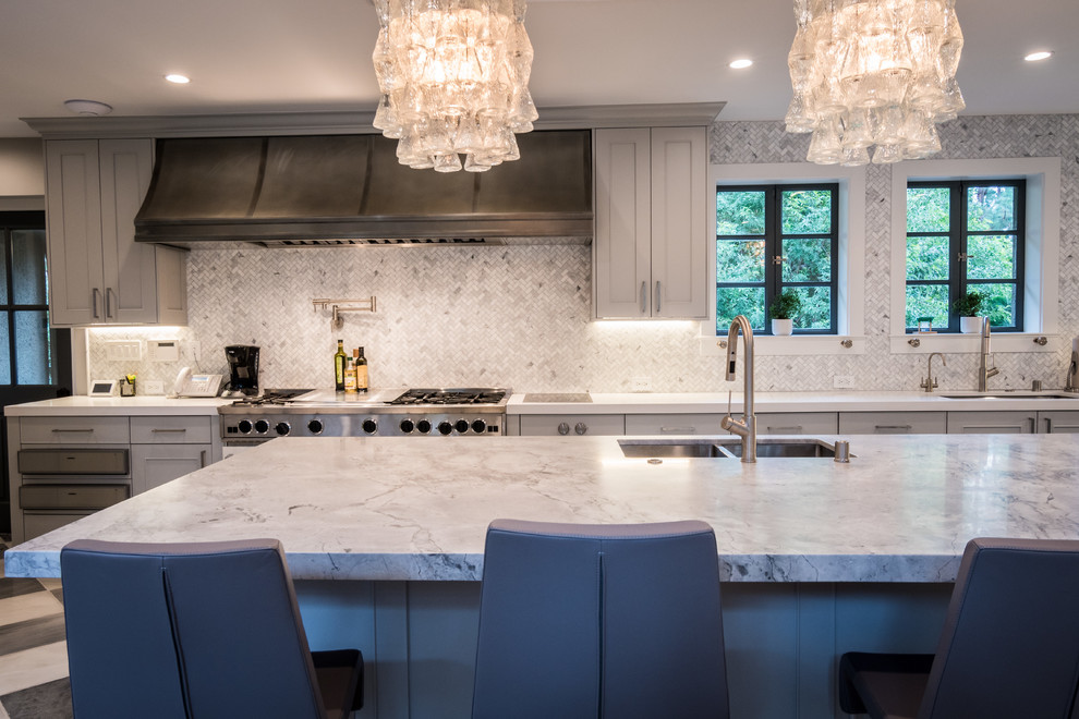 Large midcentury u-shaped eat-in kitchen in Los Angeles with an undermount sink, shaker cabinets, grey cabinets, quartz benchtops, white splashback, marble splashback, black appliances, marble floors, with island and white floor.