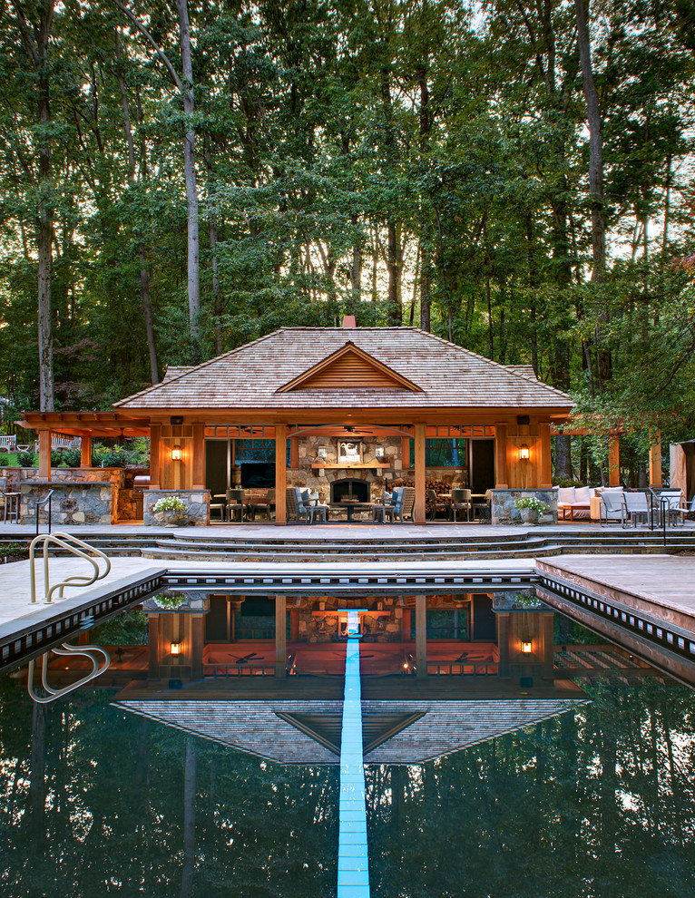Example of a mountain style backyard rectangular pool house design in DC Metro