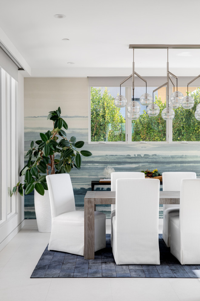 Inspiration for a large modern enclosed dining room in Orange County with multi-coloured walls, a two-sided fireplace, a tiled fireplace surround and wallpapered walls.