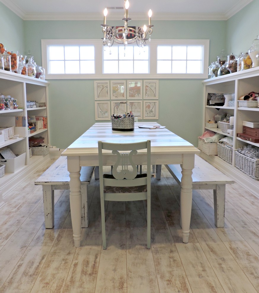 Photo of a mid-sized beach style craft room in Raleigh with blue walls, vinyl floors, no fireplace and a freestanding desk.