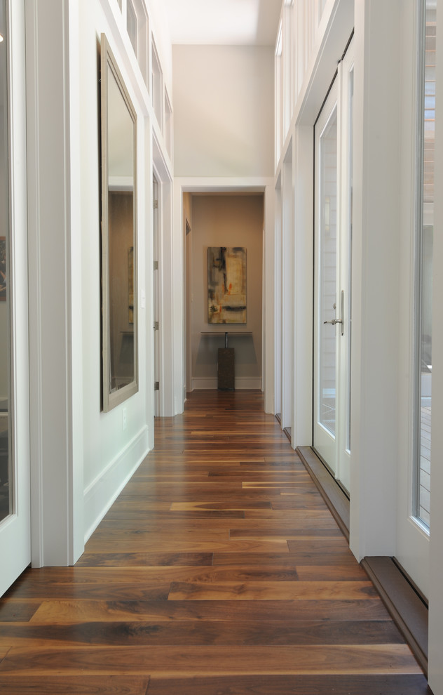 Hallway - mid-sized transitional dark wood floor hallway idea with gray walls