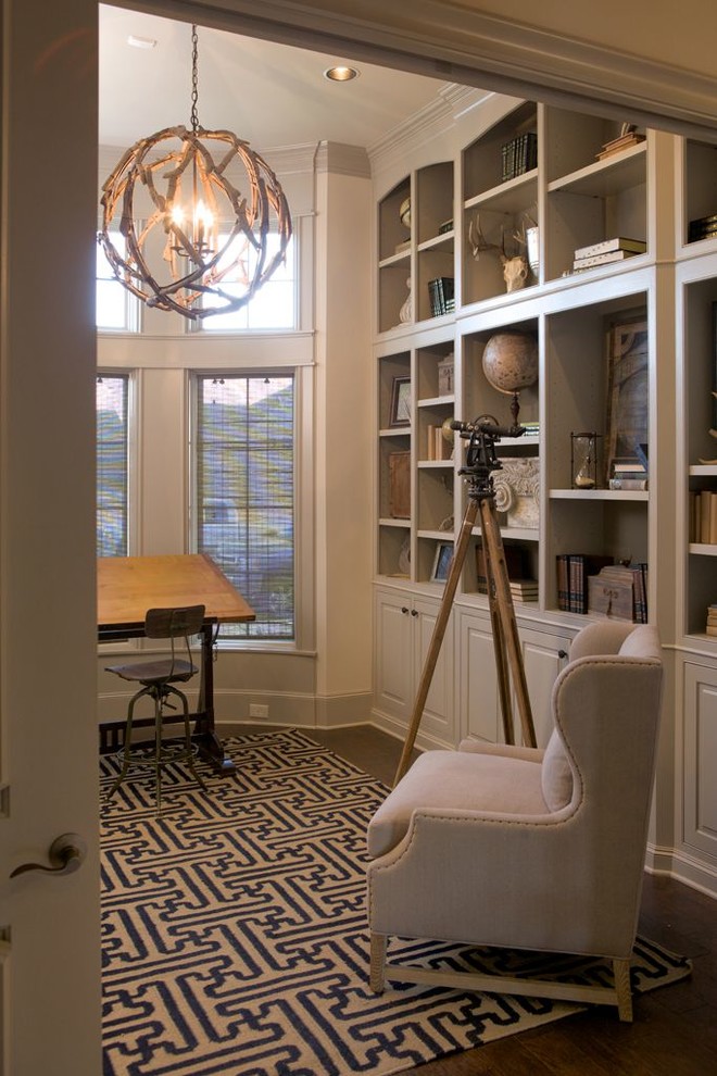 This is an example of a mid-sized traditional craft room in Austin with beige walls, dark hardwood floors, no fireplace, a freestanding desk and brown floor.