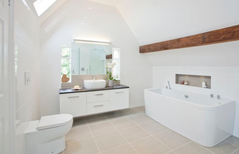 Large contemporary kids bathroom in Oxfordshire with a vessel sink, flat-panel cabinets, white cabinets, wood benchtops, a one-piece toilet, gray tile, porcelain tile, white walls and porcelain floors.