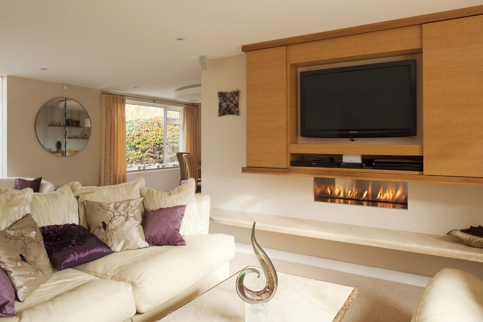Design ideas for a contemporary open concept living room in London with a ribbon fireplace and a concealed tv.