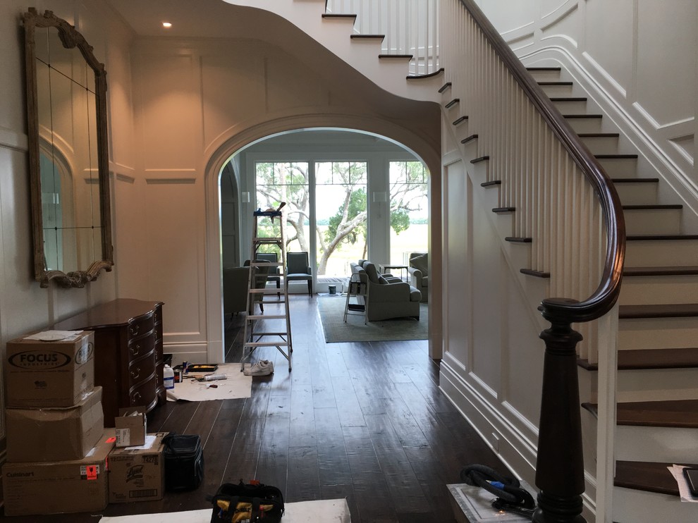 Design ideas for a large traditional foyer in Charleston with beige walls, dark hardwood floors and a single front door.