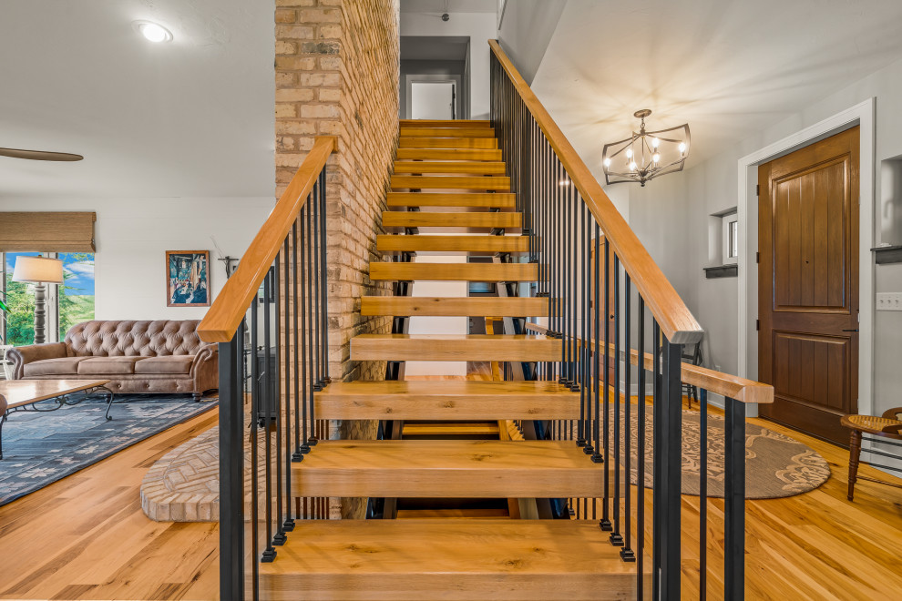 Staircase - mid-sized wooden open and mixed material railing staircase idea in Milwaukee