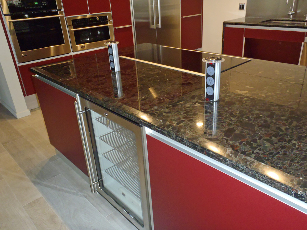 Inspiration for a contemporary l-shaped eat-in kitchen in Hawaii with an undermount sink, flat-panel cabinets, red cabinets, marble benchtops and stainless steel appliances.