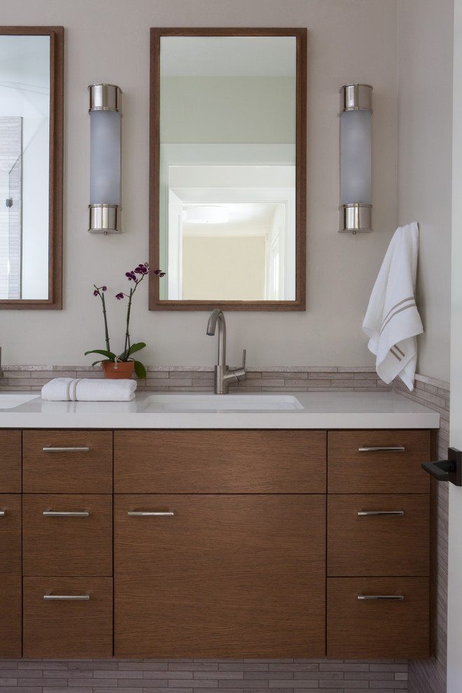 Inspiration for a mid-sized contemporary bathroom in San Francisco with flat-panel cabinets, medium wood cabinets, multi-coloured tile, beige walls and an undermount sink.