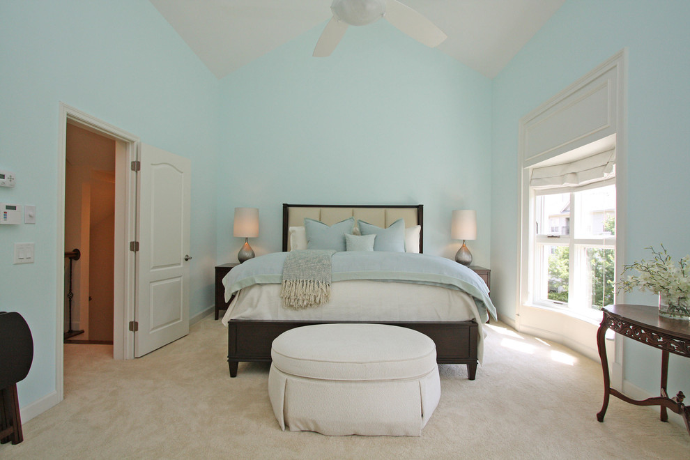 Large traditional master bedroom in Atlanta with blue walls, carpet, no fireplace and brown floor.