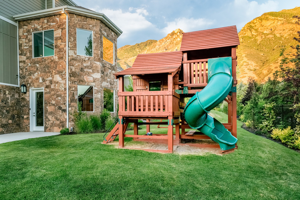 Design ideas for a transitional backyard full sun garden in Salt Lake City with with outdoor playset.