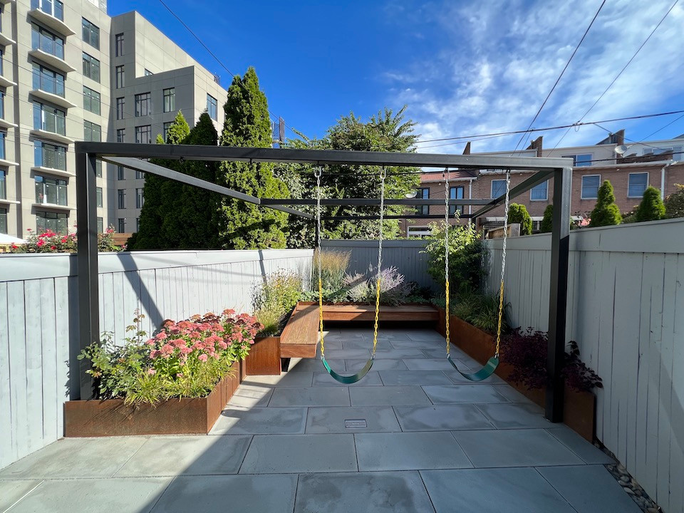 Paved patio with metal grating garden