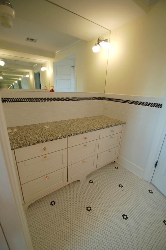 Design ideas for a small traditional kids bathroom in New York with recessed-panel cabinets, white cabinets, granite benchtops, white tile, subway tile, yellow walls, pebble tile floors and a wall-mount sink.