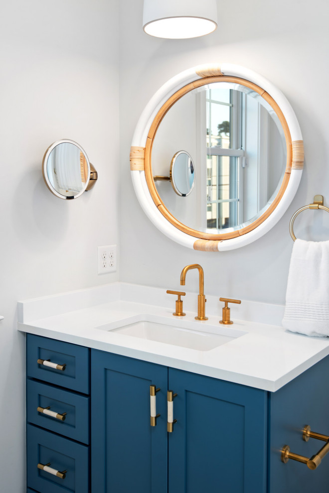 Beach style bathroom in Other with blue cabinets, white walls, white benchtops, a single vanity and a built-in vanity.