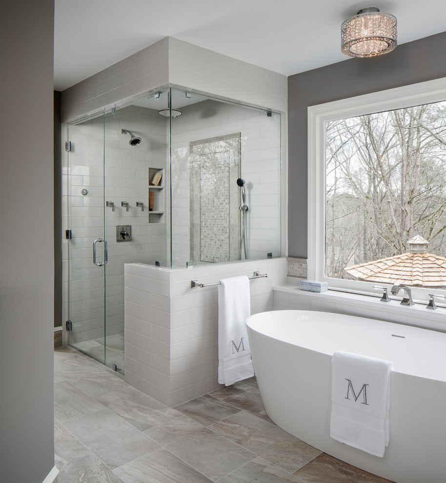 Design ideas for a large transitional master bathroom in Atlanta with a curbless shower, grey walls, a hinged shower door, grey cabinets, a freestanding tub, a two-piece toilet, gray tile, ceramic tile, porcelain floors, an undermount sink, engineered quartz benchtops and grey floor.