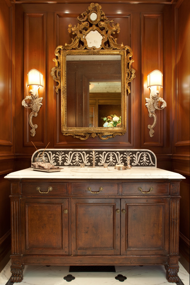 Design ideas for a large traditional powder room in San Francisco with a drop-in sink, flat-panel cabinets, dark wood cabinets, marble benchtops, brown walls and marble floors.